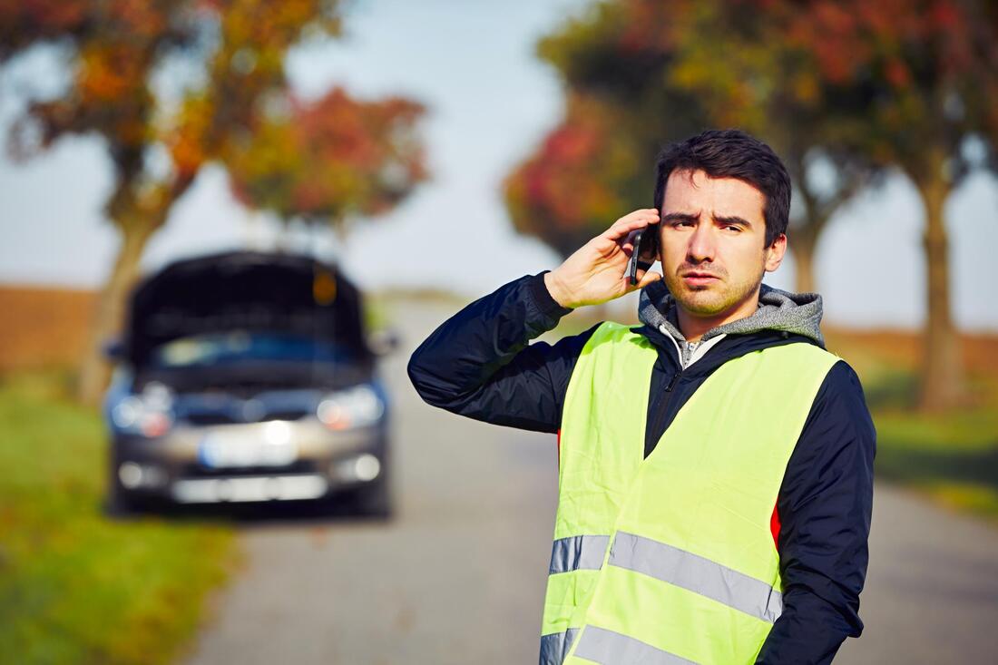 man taking phone call on road