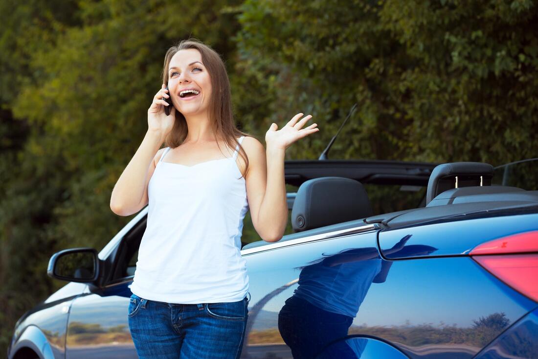 woman taking phone call on roadside